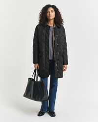 Quiltad kappa med manchesterdetaljer