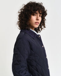 Quiltad kappa med manchesterdetaljer