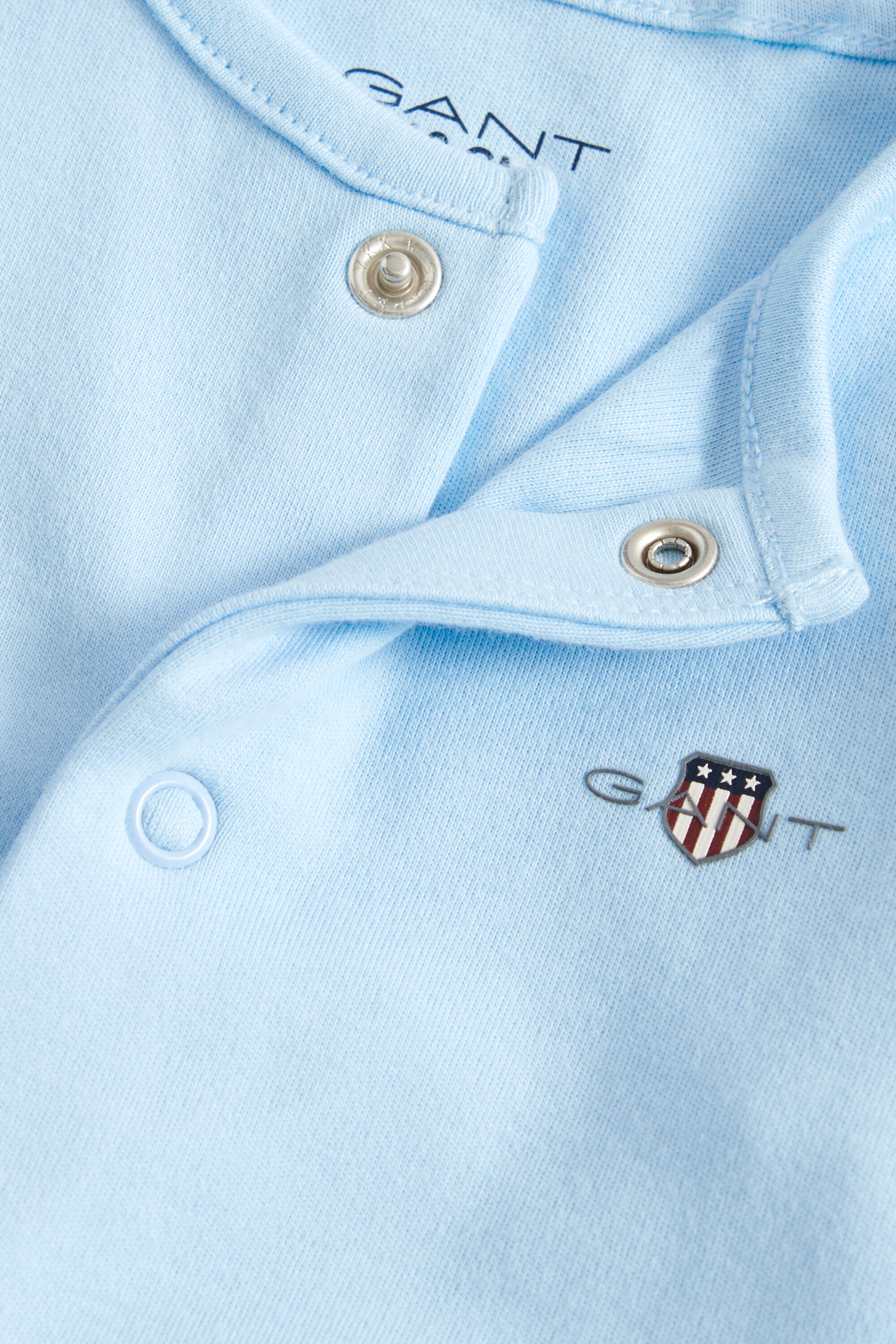 Baby långärmad sparkdräkt med sköldemblem